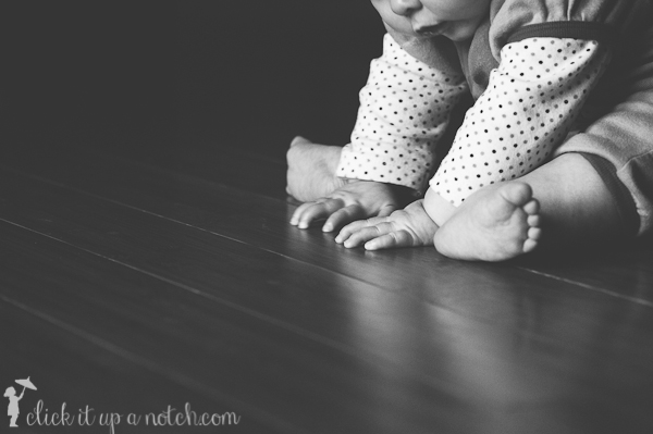 Image of a child in black and white practicing sitting up.