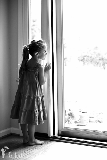 child looking outside photo in black and white.
