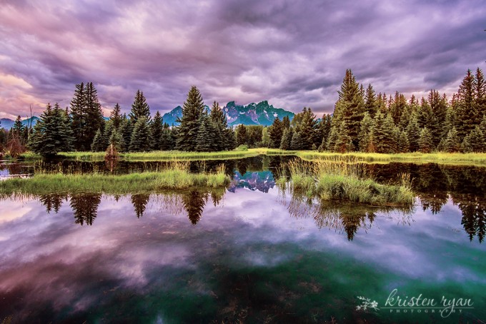 Lake and mountain scene with dramatic clouds helps show landscape photography style
