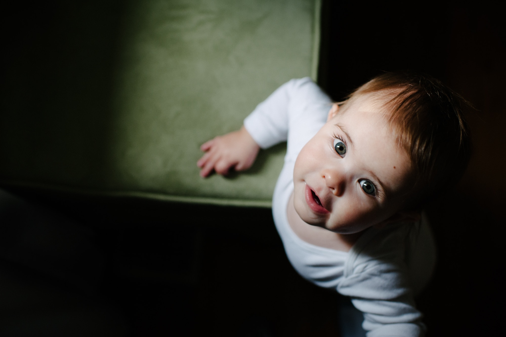 Indoor Natural Light Photography of a child looking up at the camera