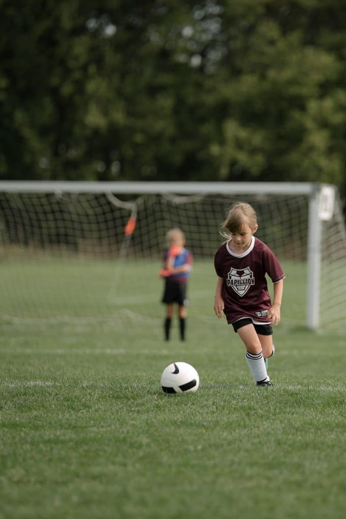 A fast shutter speed used in manual mode to capture a child playing soccer. 