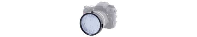 A blurred out camera and an in focus white lens screen. An expodisc is one of the best gifts for photographers.