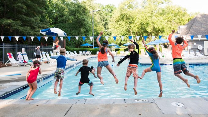 children jumping into a pool using summer photography tips to freeze motion.