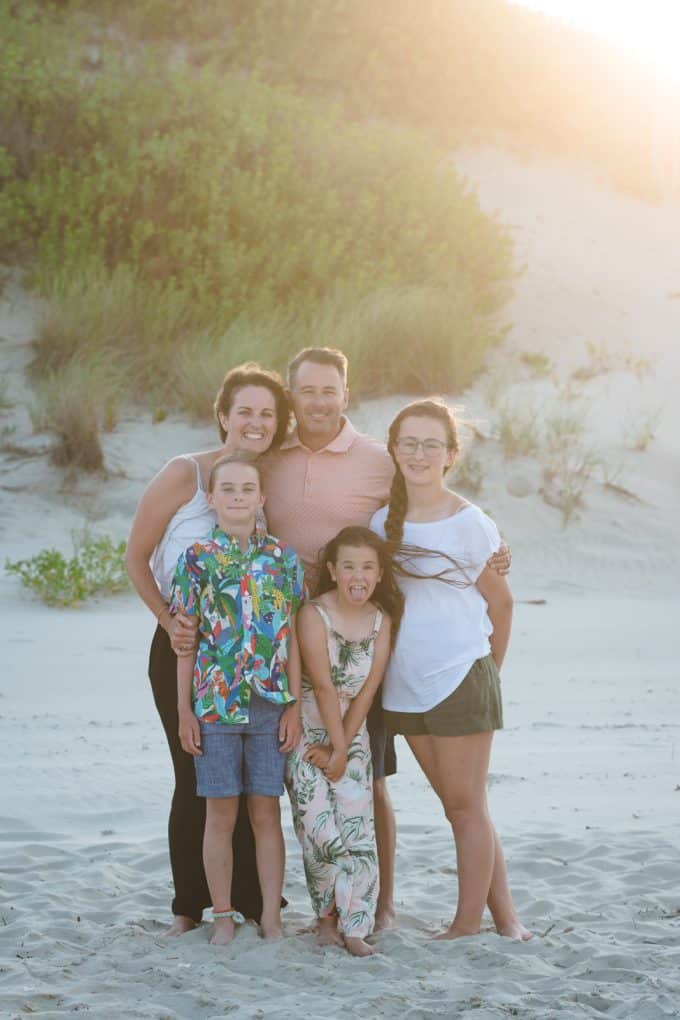 family group photo on a beach at sunset