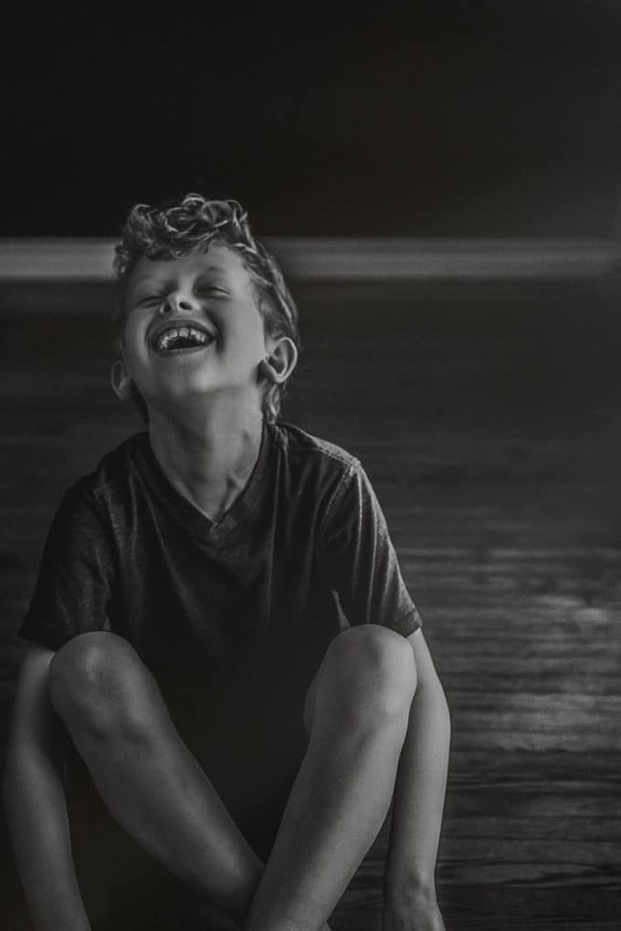 Child in black and white laughing